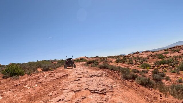 Driving off road red rock desert 4x4 Utah following POV. Southern Utah desert Sand Hollow. Red sandstone, dirt, sand trails. Outdoor extreme 4x4 recreation ride and adventure. Recreation.
