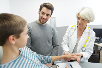 Fototapeta premium sick little boy with doctor and dad