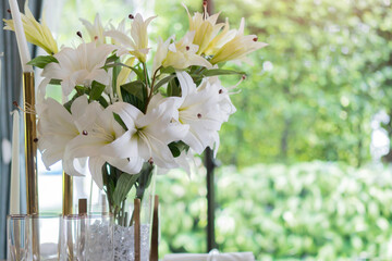 Flower decorations on the banquet table, prepared for event party or wedding on nature background.