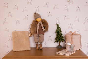Decor on the shelf in the children's room. Toy, Christmas tree, gift box and notepad