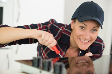 woman installing induction hobs in kitchen
