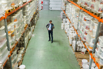 high angle view of man between racking in warehouse