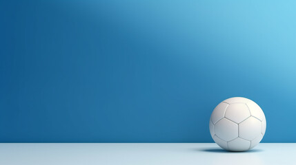 Fototapeta premium Soccer ball on blue wall background with copy space