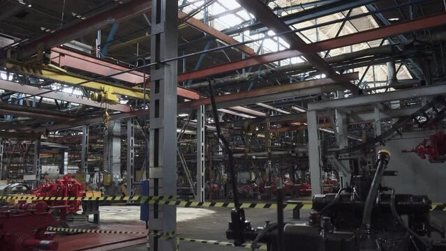 Space in factory production workshop is fenced off with tape to prevent access by people. Shutdown machine-building plant during legal proceedings. Bankruptcy of large enterprise due to crisis.