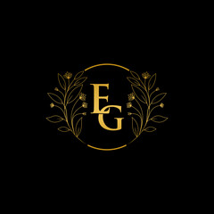 Golden floral letter E and G logo Icon, Luxury alphabet font initial design isolated on black background