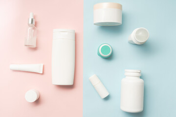Creative flat lay of cosmetic bottles and jars on two colored background