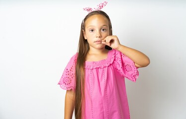beautiful kid girl wearing pink dress mouth and lips shut as zip with fingers. Secret and silent,...