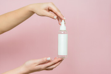 Cosmetic bottle in woman's hands. Cosmetic product branding mockup. Spa beauty treatment concept