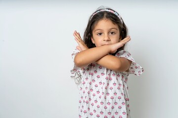beautiful kid girl wearing dress Rejection expression crossing arms doing negative sign, angry face