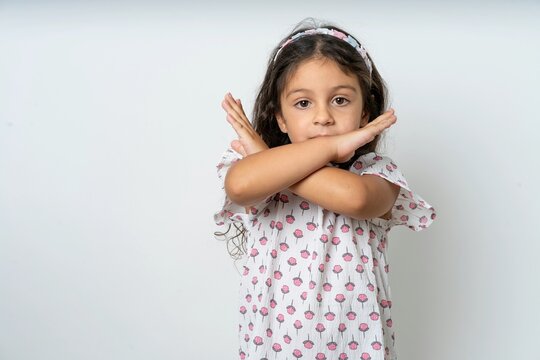 beautiful kid girl wearing dress Rejection expression crossing arms doing negative sign, angry face