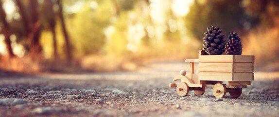 Nostalgic and magical image of wooden car in the forest at sunset