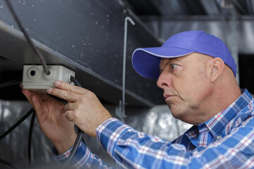 man working with cables indoors