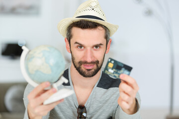 man holding card and globe
