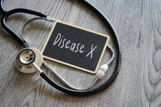 Closeup image of stethoscope and text DISEASE X on table. Medical and healthcare concept
