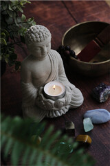 stone statue of buddha with a candle