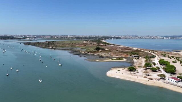 Drone shot flying in over  field on small island from the water (Portugal).