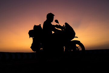 biker men and classic motorcycle at sunset