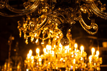 A room with a beautiful sparkling chandelier,
