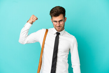 Business man over isolated background doing strong gesture