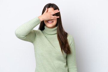 Young Brazilian woman isolated on white background covering eyes by hands and smiling