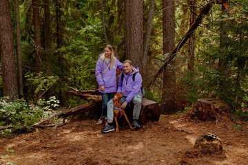 Couple with a dog in nature in the forest walking © Stanislava