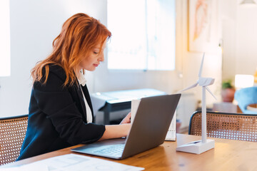 Serious, laptop and professional businesswoman sitting and reading a work email with a pen working from home. Business, computer and focused female lawyer in modern office preparing for a case.