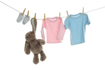 PNG line drying baby clothes isolated on white background.