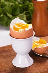 Close-Up of Poached Egg in Eggshell in White Cup in 4k Image