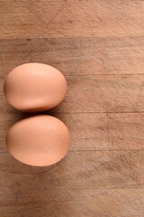 Top View Close-up of Fresh Brown Eggs on Wooden Table - 4K Image