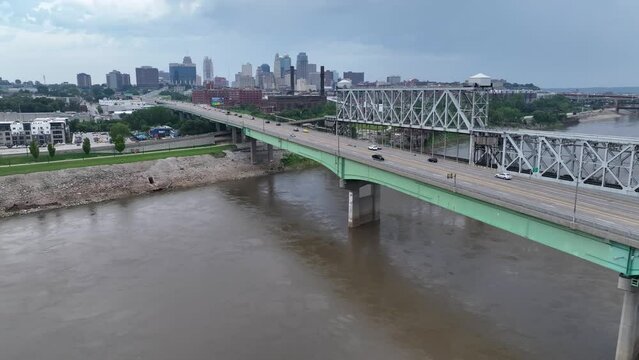 Heart of America Bridge over Missouri River with view of downtown Kansas City. Aerial establishing shot on cloudy summer day.