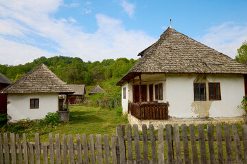 Fototapeta na wymiar Landscape with old houses with local architecture from Romania somewhere in Transylvania.