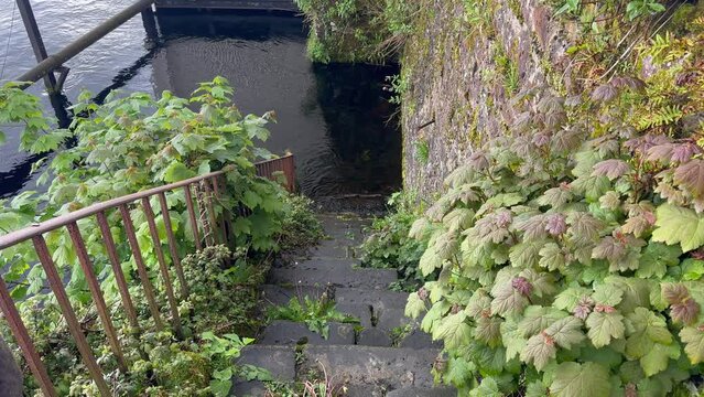 Old stone steps lead directly down into water on River Shannon, IRE