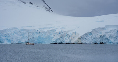 Sailboat by a Glacier in Antarctica  - 653189889