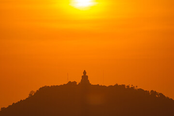 scenery yellow sky glare of sun above Phuket big Buddha.Phuket Big Buddha is one of the island most important and revered landmarks on the island..image for travel and culture concept. © Narong Niemhom