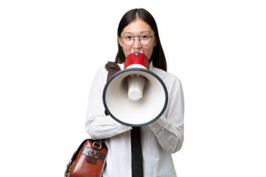 Young Asian business woman over isolated background shouting through a megaphone