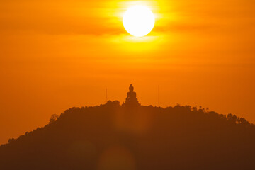 scenery yellow sky glare of sun above Phuket big Buddha.Phuket Big Buddha is one of the island most...