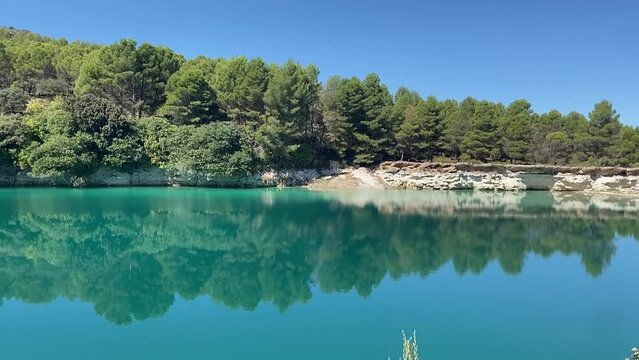 The turquoise and crystal-clear waters of Laguna Lengua in the Lagunas de Ruidera, Albacete, Castilla-La Mancha, Spain