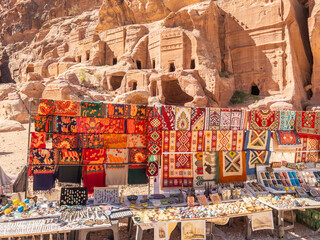 Shawls and rugs for sale at the Street of Facades, Petra Archaeological Park, UNESCO World Heritage Site, one of the New Seven Wonders of the World, Petra, Jordan