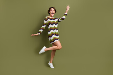 Full length photo of sweet pretty lady wear striped outfit waving arm hi empty space isolated khaki color background