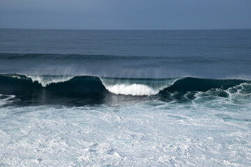 beach waves on a sunny morning, beach waves break the calm on the beach