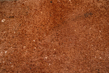 The grunge texture of terracotta plaster. Rough wall treatment, rough wall. Textured background
