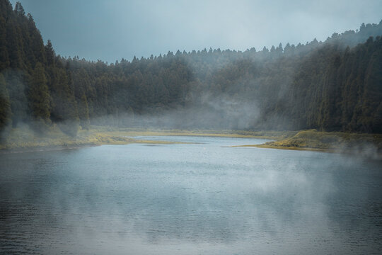 Fototapeta Lagoa do Eguas lake framed by a forest in a cloudy day with some low fog, Azores islands, Sao Miguel island, Portugal, Atlantic