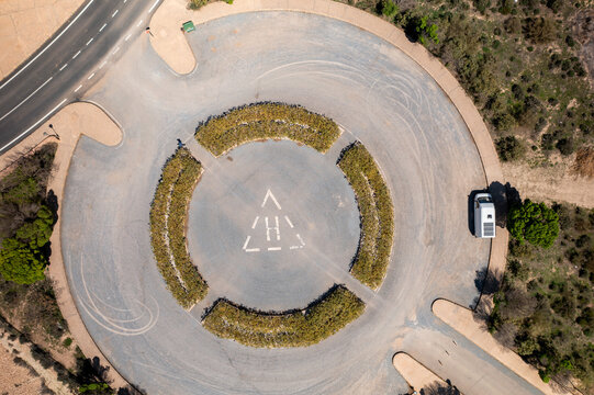 Drone aerial view of a helicopter landing parking on a desert like landscape at Francisco Abellan Dam, Granada, Andalusia