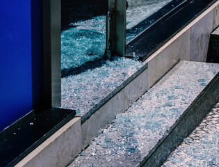 Broken glass in front of a business on the street after robbery or vandalism