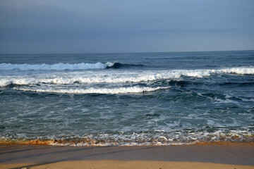 beach waves on a sunny morning, beach waves break the calm on the beach