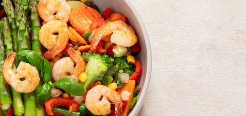 Stir fried shrimps with asparagus, vegetables. Cooked healthy food.