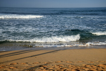 beach waves on a sunny morning, beach waves break the calm on the beach