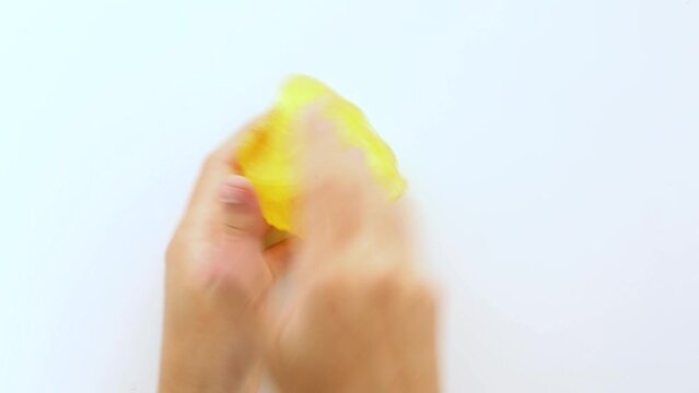 Asmr. The teenager's hands stretch the yellow, soft, sticky slime