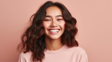 Fototapeta premium A beautifully lit studio portrait reveals the genuine happiness of a teenage girl, making her smile truly shine.