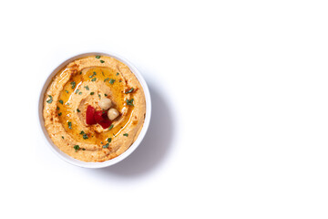 Roasted red pepper hummus in white bowl isolated on white background. Top view. Copy space